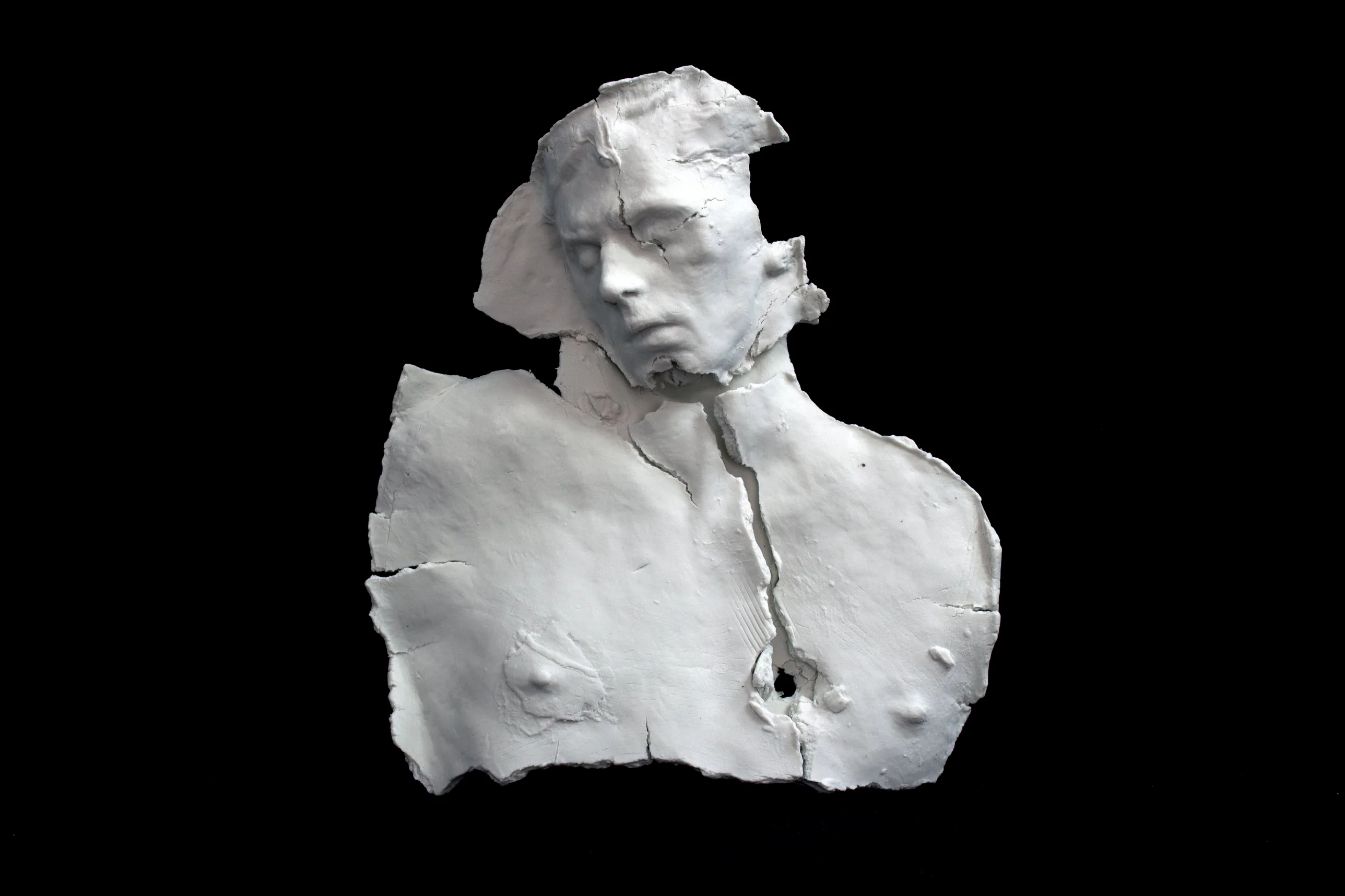 emrys, white porcelain head and torso, broken and reassembled, eyes closed, against a black ground