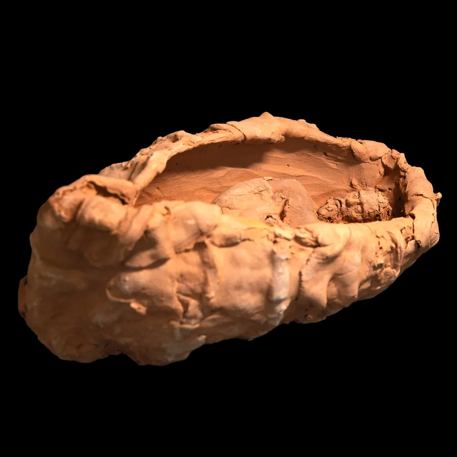 blith, terracotta vessel with a figure lying inside, three-quarter view