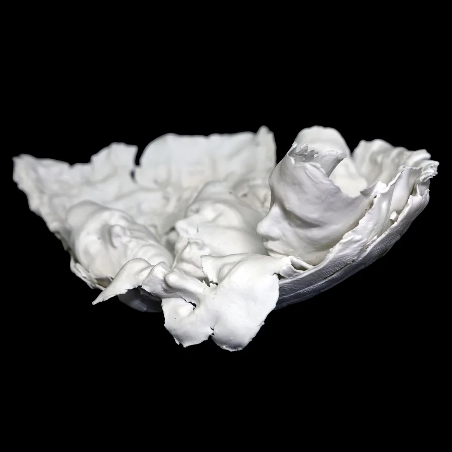 veritas, side view of the white porcelain bowl with a small figure lying in its hollow