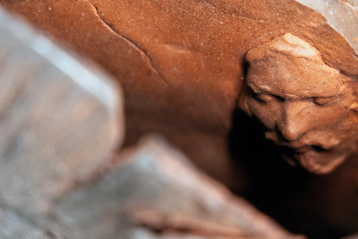 fan form 2, signature: a small face modelled in the clay