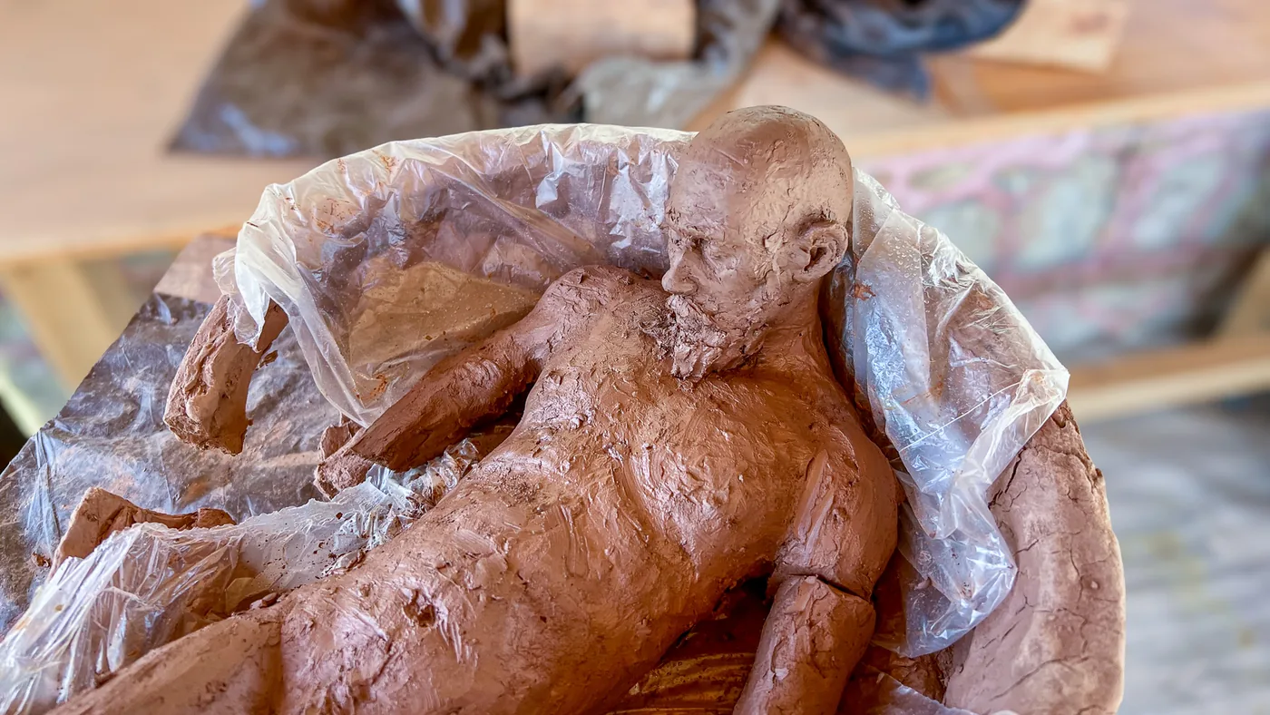 arkard before firing, the figure lying in the bowl, partly wrapped in plastic